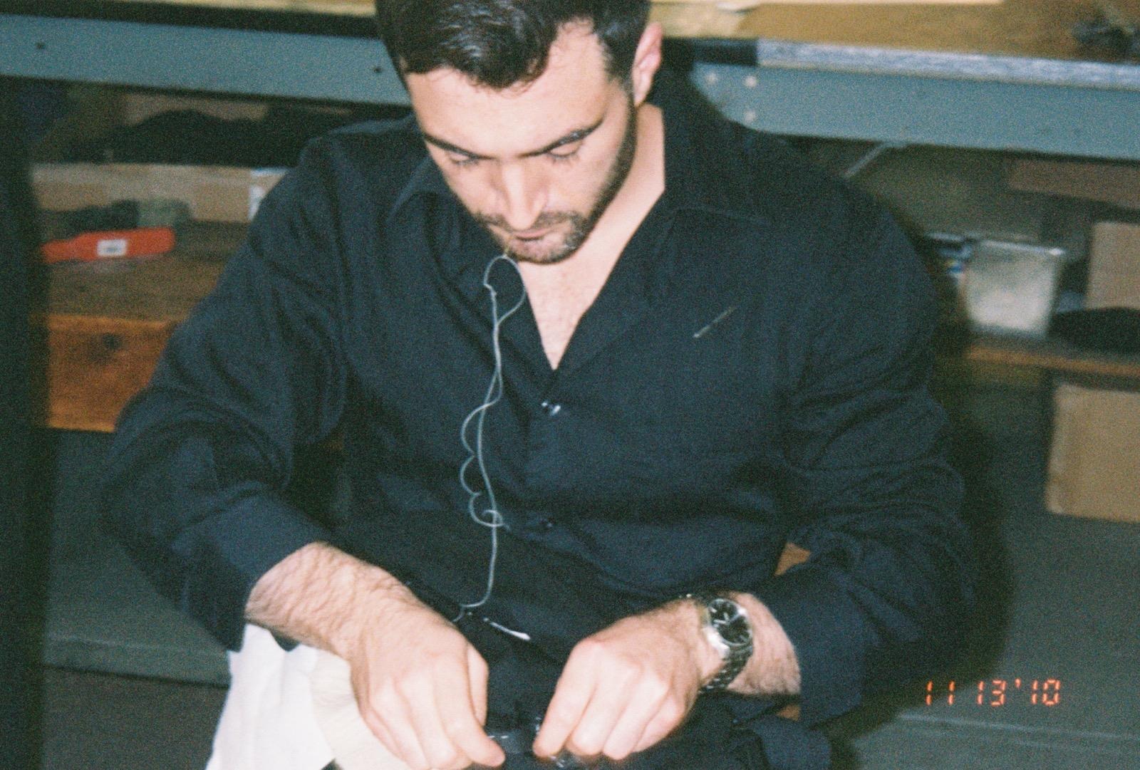 Tristan Michael working by hand on the internal construction of a bespoke garment.